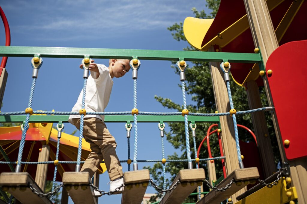 young-boy-having-fun-outdoors-playground-min
